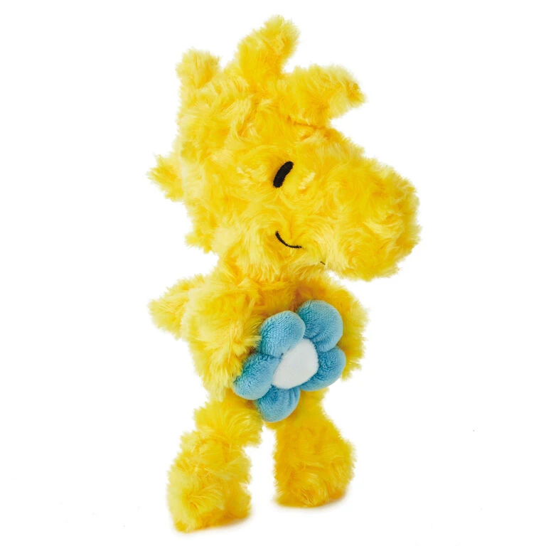 Woodstock stuffed animal holding flower