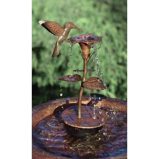 Copper Hummingbird Dripper Fountain in garden setting