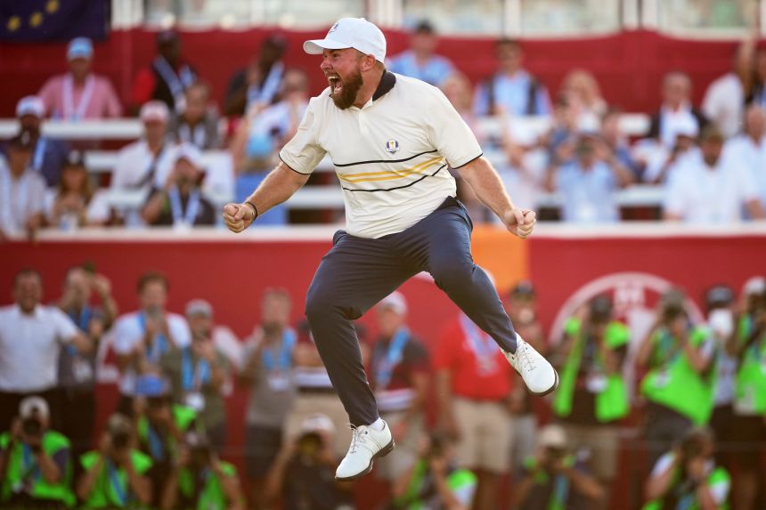 Shane Lowry jumps for joy after hitting the putt that ensured Europe would retain the Ryder Cup.