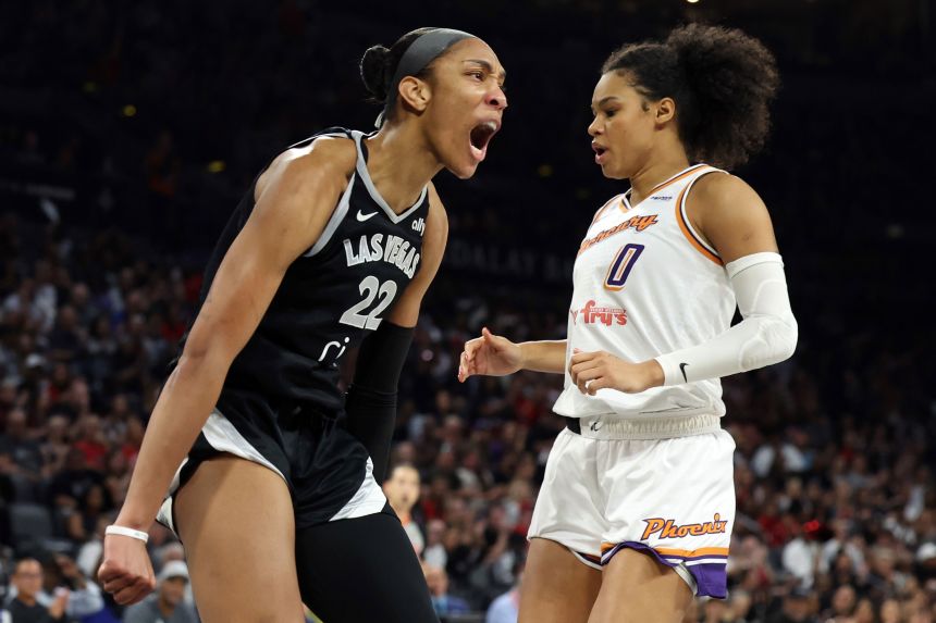 A'ja Wilson of the Las Vegas Aces celebrates in front of Satou Sabally of the Phoenix Mercury after making a basket in the second quarter in Las Vegas on Sunday.